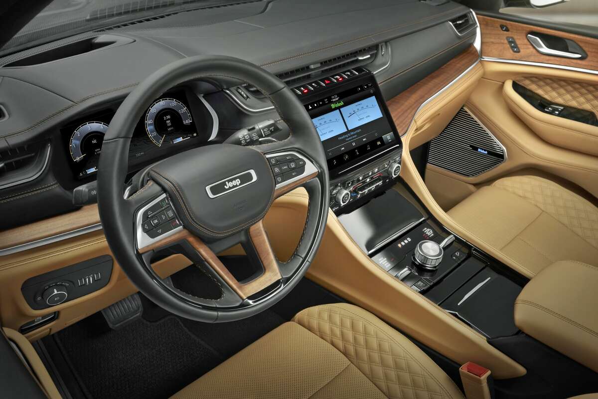 The 2021 Jeep Grand Cherokee L Summit Reserveâ&#128;&#153;s interior features 3  rows of seating; a frameless integer  gauge clump   and 10.1-inch Uconnect 5 touchscreen radio; hand-wrapped, quilted Palermo leather upholstery; and open-pore Waxed Walnut wood   accents.