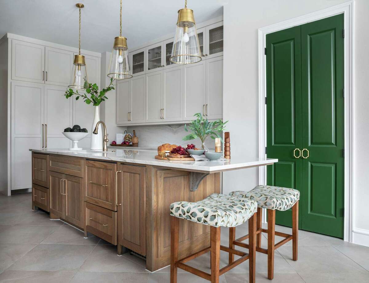 Emerald green was a factor in one home's kitchen pantry doors and in a nearby bar designed by Houston interior designer Rainey Richardson.