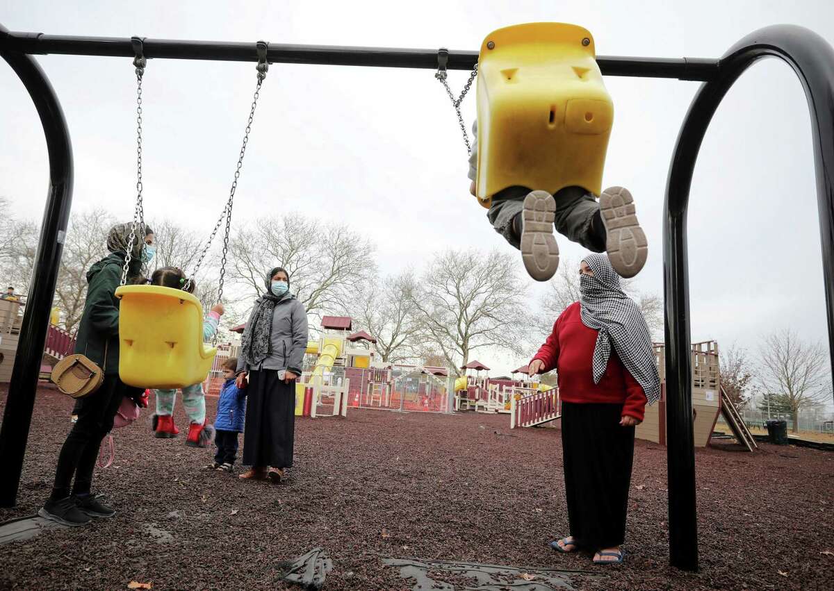 Afghan refugee mothers and children play in a park in Liberty Village on Dec. 2 in Joint Base McGuire-Dix-Lakehurst, N.J.