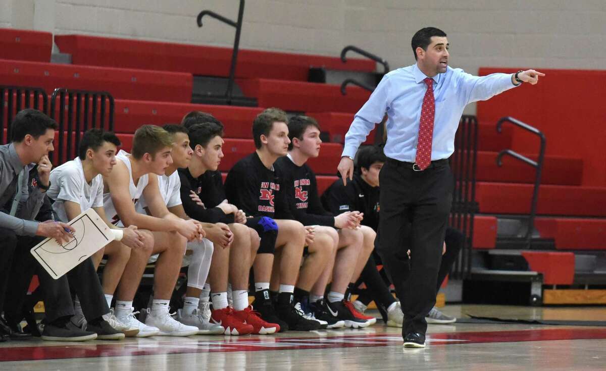New Canaan boys basketball coach Danny Melzer directs the Rams during a game at NCHS.