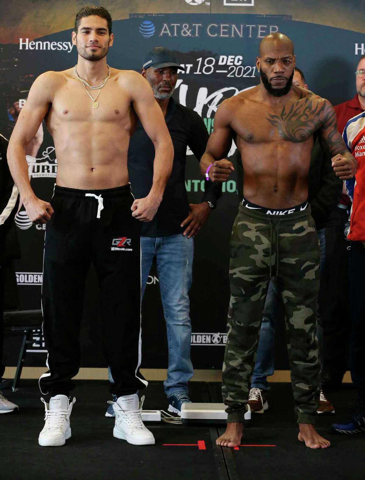 Gilberto ?’Zurdo?“ Ramirez, left, of Mazatlan, Mexico and Yunieski Gonzalez, out of Miami, flex after weighing in at the Grand Hyatt, Friday, Dec. 17, 2021. They are the main event for Saturday?•s night boxing at the AT&T Center.