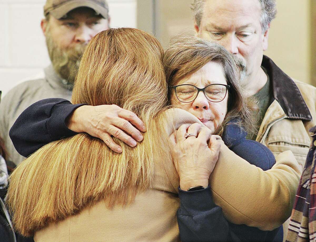 Carla Cope, right, of Brighton, mother of Amazon warehouse tornado victim Clayton Lynn Cope, 29, of Alton, gets an emotional hug Friday from State Sen. Rachelle Crowe, D-Glen Carbon, at a memorial service in Edwardsville to remember the six Amazon employees who lost their lives when half of the building collapsed on December, 10. The memorial was held in Edwardsville Fire Station Number 1.