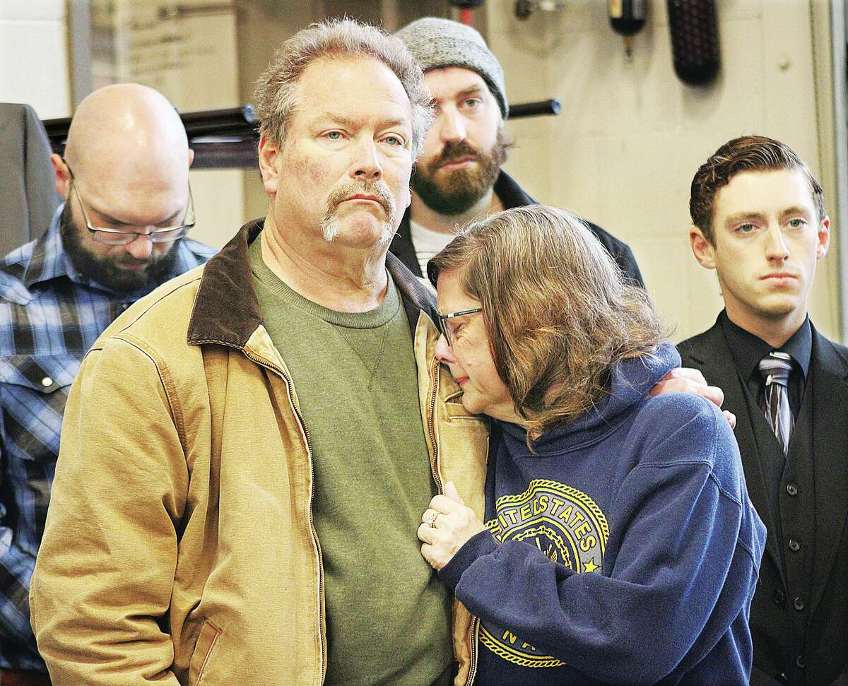 Families of those who died in the fatal collapse of the Amazon warehouse facility in Edwardsville on December 10, including Carla and Lynn Cope, center, of Brighton, parents of Clayton Lynn Cope, 29, of Alton, grieve Friday at a memorial service held in Edwardsville. Six people died one week ago when an EF3 tornado struck the warehouse.