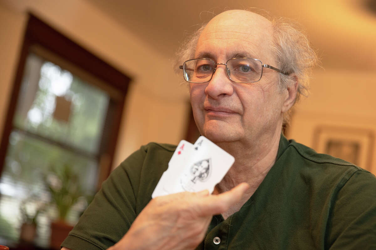 JP Massar poses with some playing cards at his house in Berkeley, Calif., on Dec. 13, 2021. Massar is an expert-level blackjack player whose story was fictionalized in the movie "21."