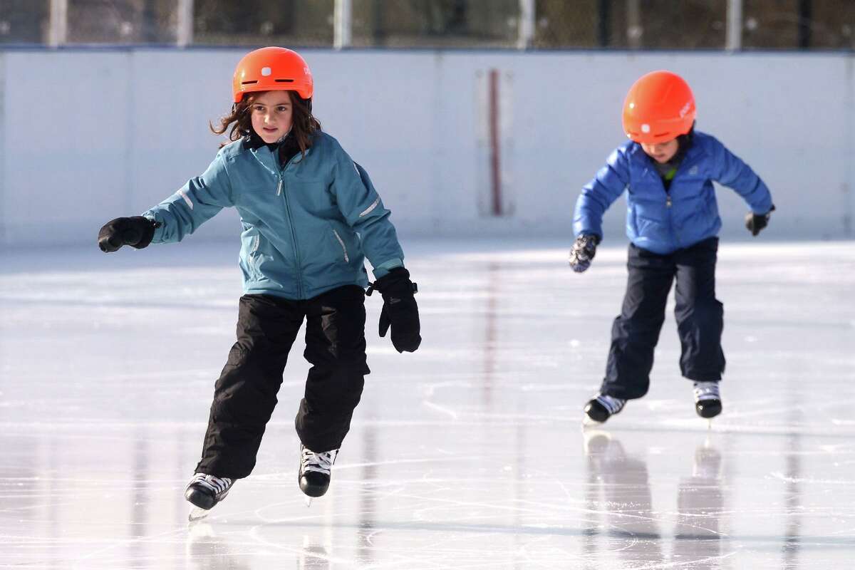 Sylvie and Shane Hayden, of Westport, enjoy an afternoon of ice skating at the outdoor PAL Rink at Longshore, in Westport, Conn. Dec. 17, 2021.