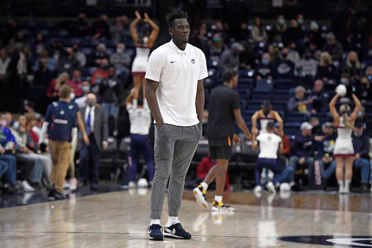 UConn’s Adama Sanogo watches his team warm up before a game against Grambling State on Dec. 4 in Storrs.