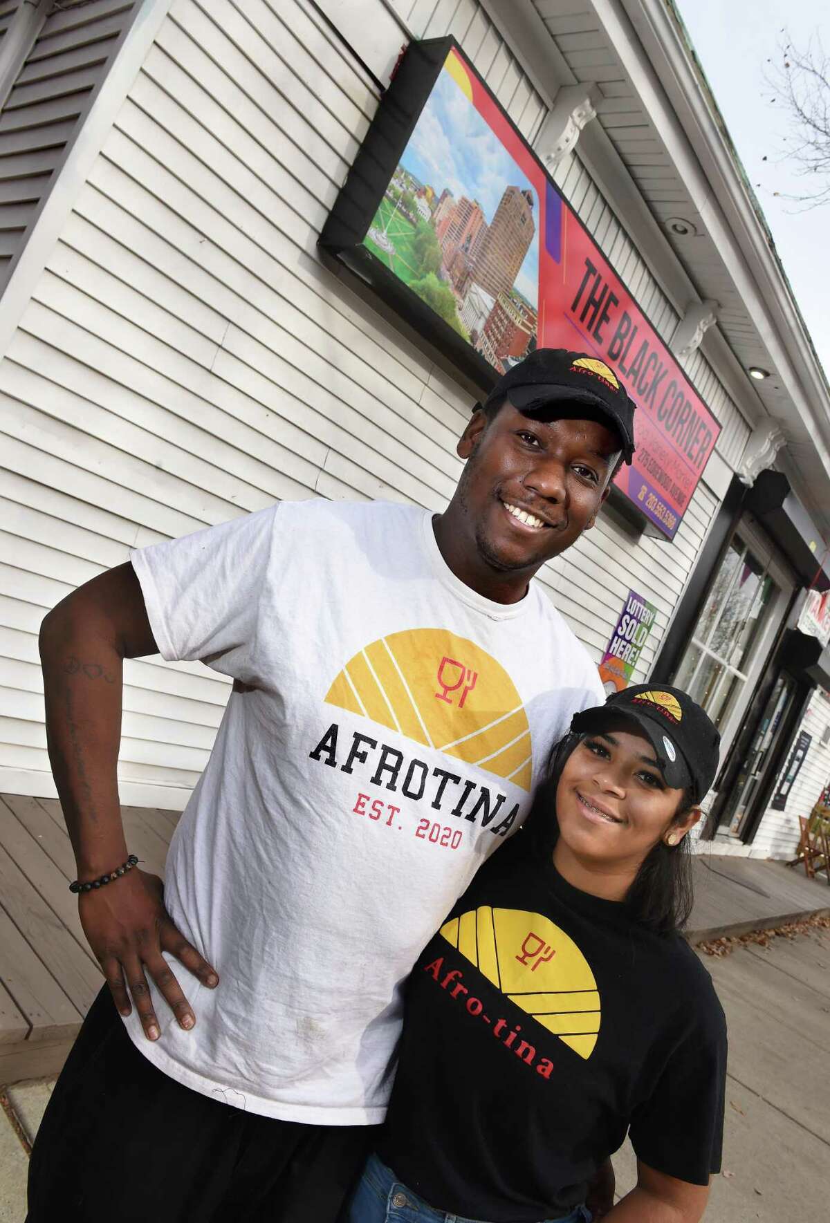 Ohioma Odihirin, left, and his wife, Eternaty, are photographed in front of the Black Corner store on Edgewood Avenue in New Haven.