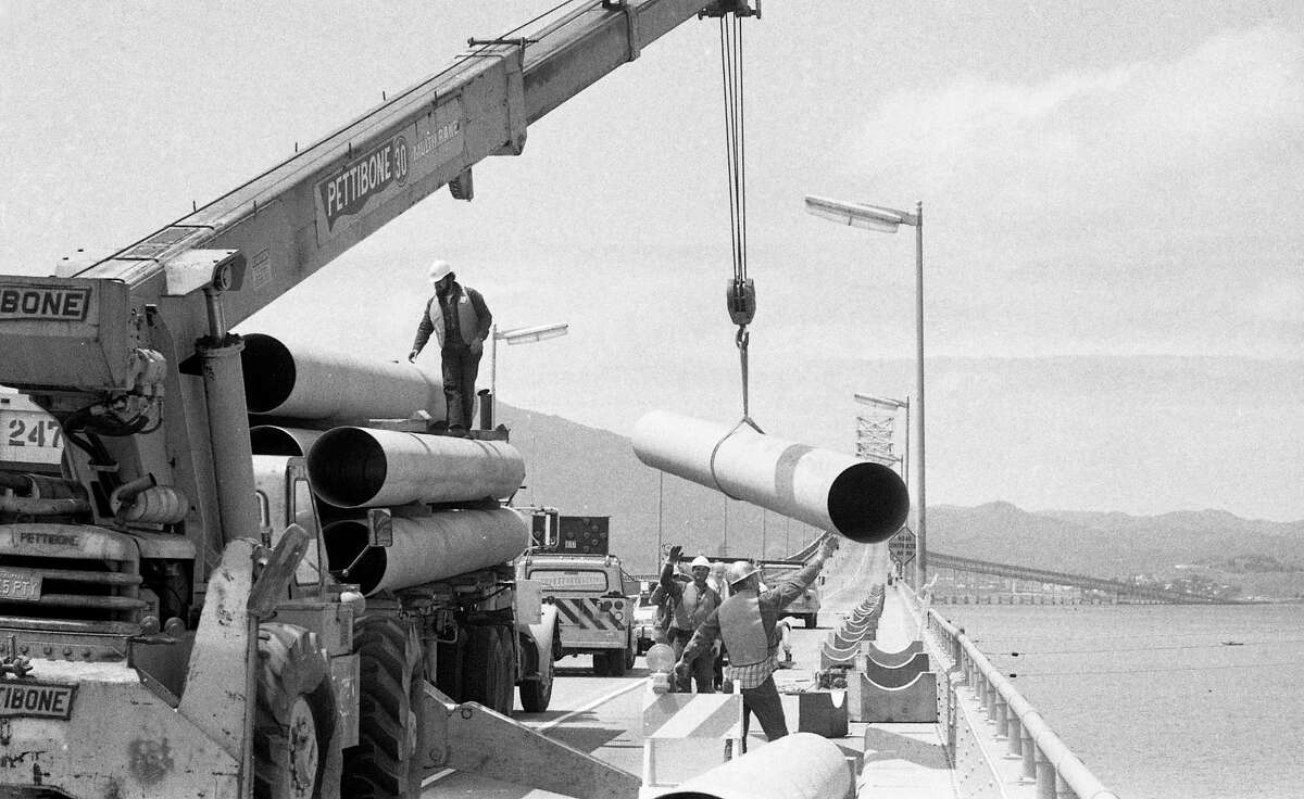 Construction workers assemble a pipeline from Contra Costa County across an open lane of the Richmond/San Rafael Bridge on May 3, 1977, to carry water to drought-stricken Marin County during the later stages of the 1976-1977 California drought.