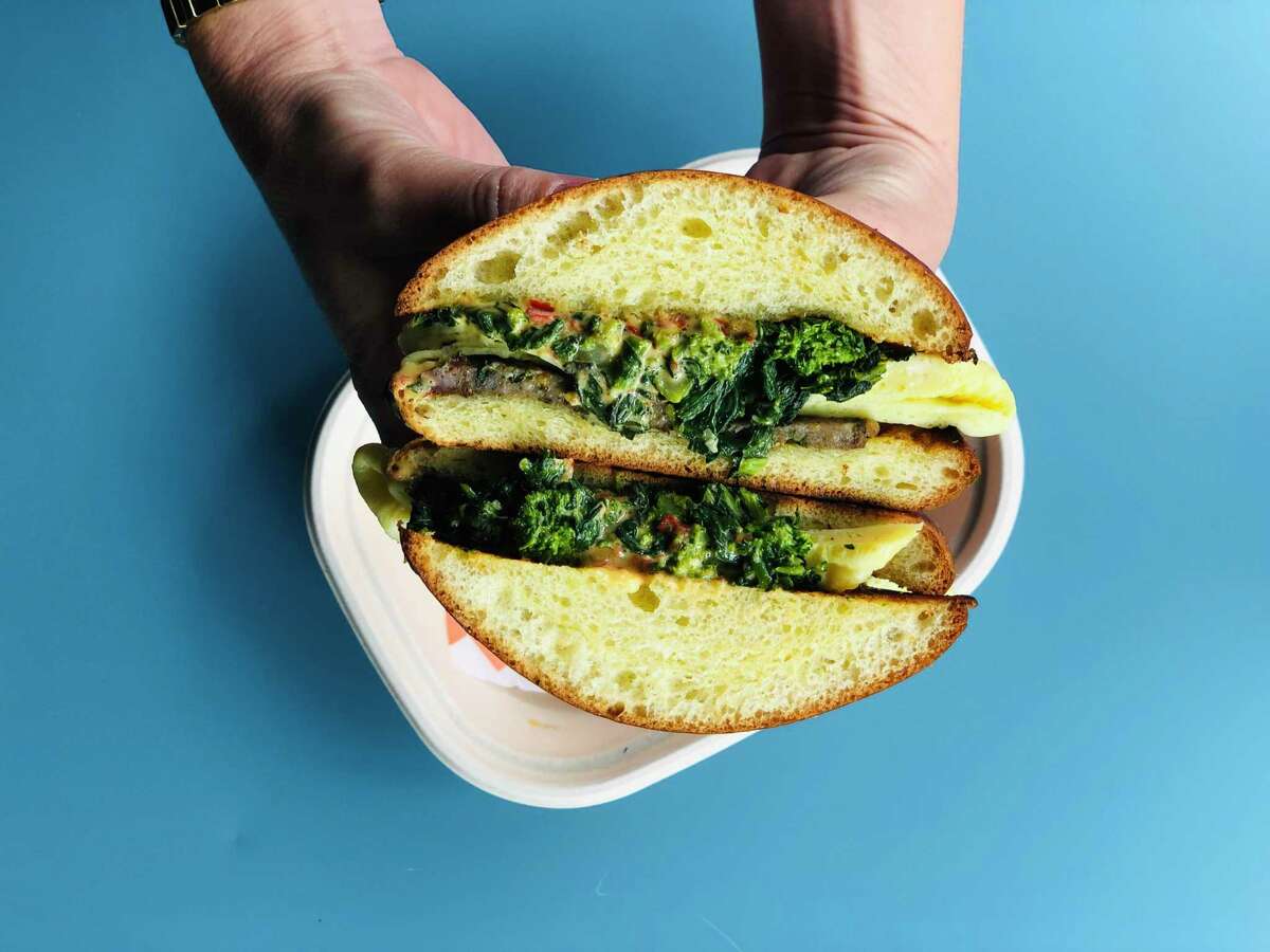 A look inside the Brekky Sandwich, served during a Poppy pop-up in San Francisco. It features eggs, garlicky broccoli rabe and Calabrian chile cheddar sauce on a brioche bun.