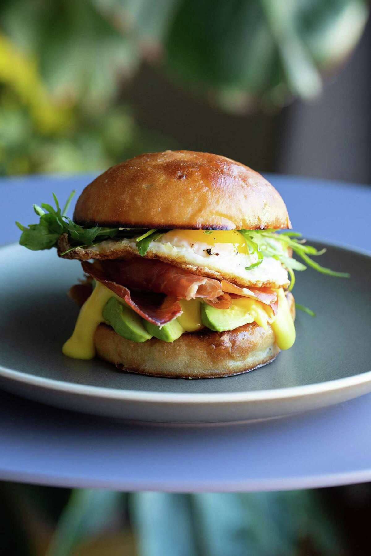 A breakfast sandwich with prosciutto, egg and avocado from Poppy.