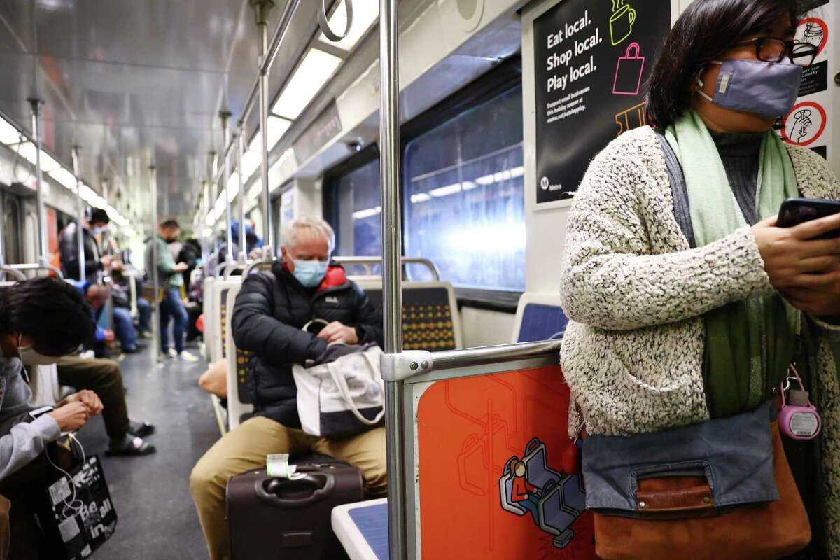 Passengers wear face coverings aboard a Los Angeles Metro Rail train.