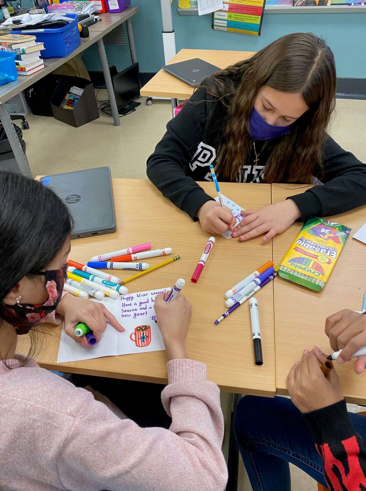 Strawberry Hill students (left to right) Rhea Sadhu and Bella Montagna create holiday cards to go into gift bags for Stamford seniors as part of SilverSource’s “Caring Connections” program.