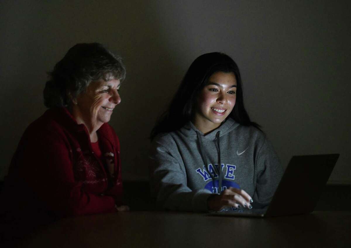 DHS junior Victoria Caruso poses with her computer science teacher Lorraine Westervelt at Darien High School in Darien, Conn. Wednesday, Dec. 15, 2021. Caruso won the Congressional App Challenge for Connecticut District 4 by creating Blossom, a wellness app that allows users to track their progress towards building healthy habits such as exercise, sleeping more, and drinking more water.