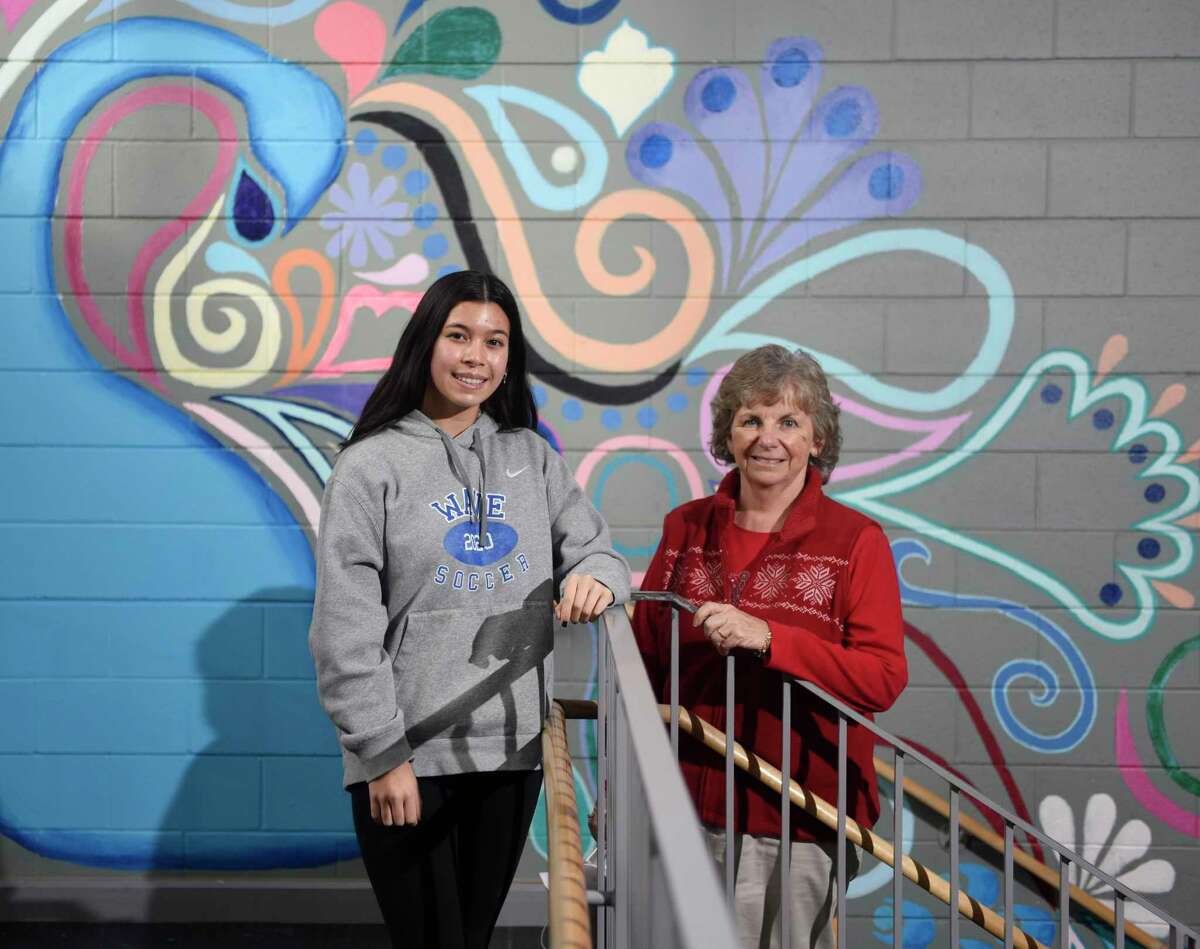 DHS junior Victoria Caruso poses with her computer science teacher Lorraine Westervelt at Darien High School in Darien, Conn. Wednesday, Dec. 15, 2021. Caruso won the Congressional App Challenge for Connecticut District 4 by creating Blossom, a wellness app that allows users to track their progress towards building healthy habits such as exercise, sleeping more, and drinking more water.