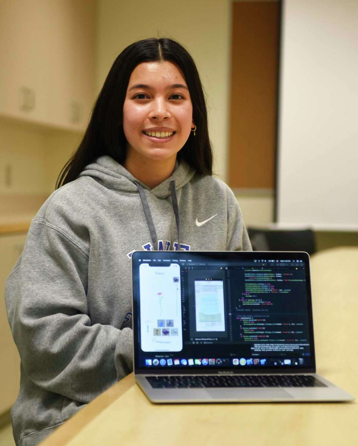 DHS junior Victoria Caruso shows the coding of her new app Blossom at Darien High School in Darien, Conn. Wednesday, Dec. 15, 2021. Caruso won the Congressional App Challenge for Connecticut District 4 by creating Blossom, a wellness app that allows users to track their progress towards building healthy habits such as exercise, sleeping more, and drinking more water.