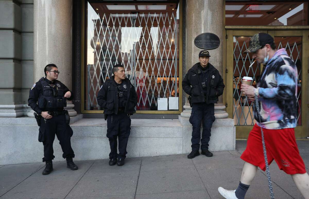 San Francisco police officers monitor stores in Union Square on Nov. 26. For better or worse, police officers in the United States carry firearms.