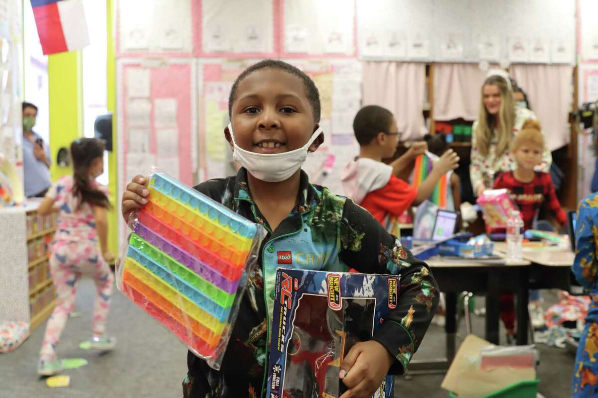 A Thornwood Elementary School student happily holds the gift that he received during a Dec. 16 event that was a partnership between Lily's Toy Box and Alex Bregman and his wife Reagan.