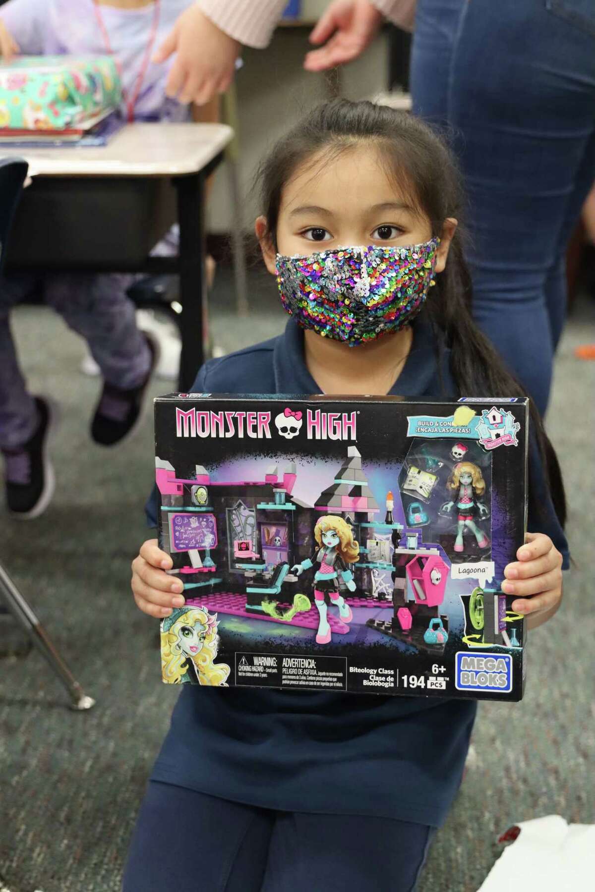 A Thornwood Elementary School student happily holds the gift that she received during a Dec. 16 event that was a partnership between Lily's Toy Box and Alex Bregman and his wife Reagan.