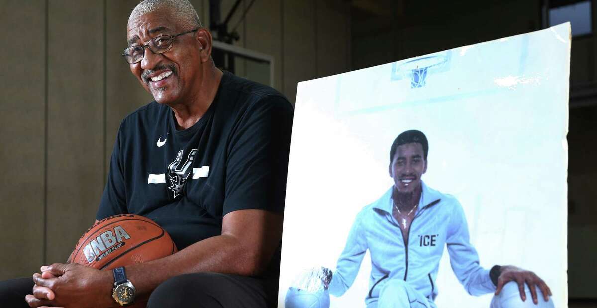 San Antonio Spurs legend George Gervin poses with his iconic 1978 Nike poster at his educational academy.