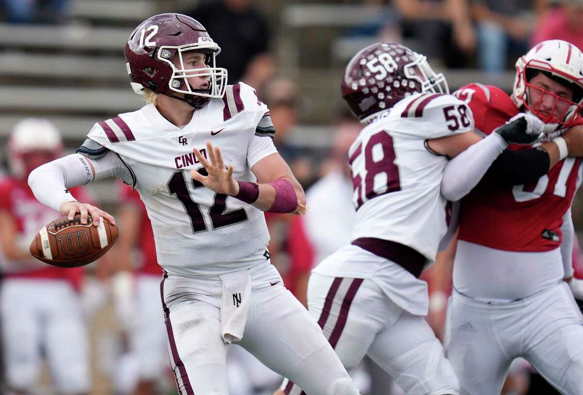 Cinco Ranch quarterback Gavin Rutherford (12) looks to pass during the first half of a high school football playoff game against Memorial, Saturday, Nov. 20, 2021, in Houston.