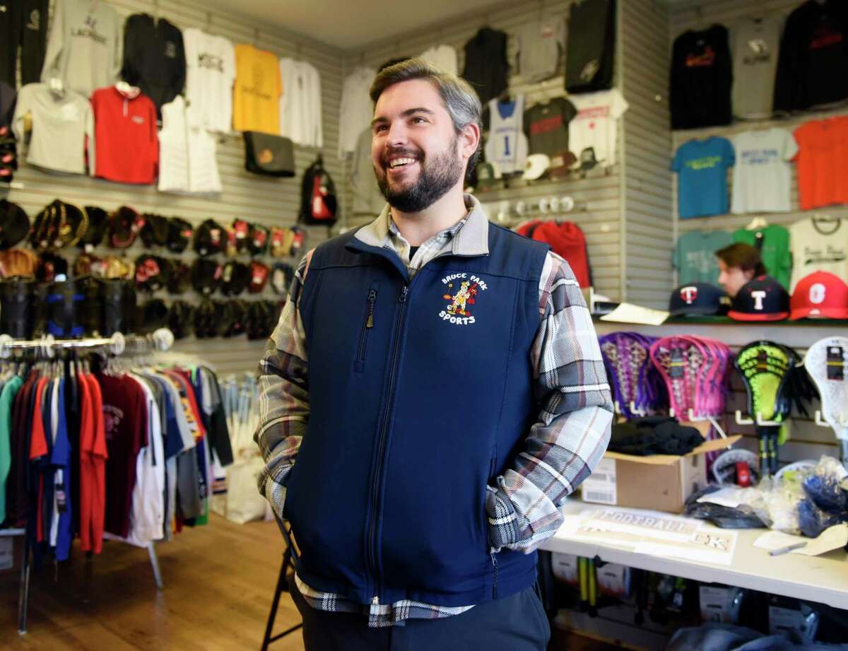 Owner Mark Bisanzo chats inside Bruce Park Sports in Greenwich, Conn. Monday, Dec. 13, 2021. The family-owned sporting goods store is celebrating its 50 year anniversary.