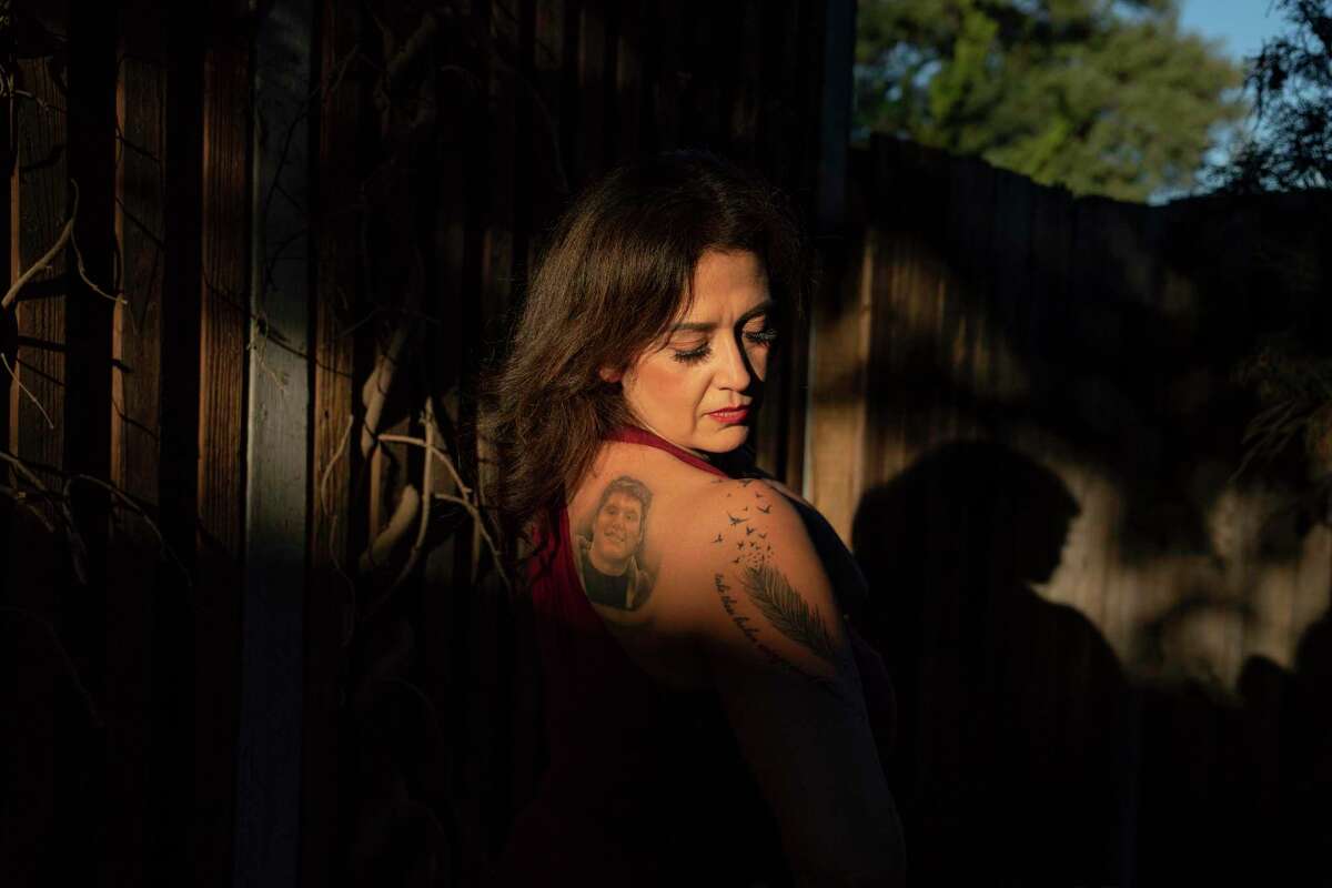 Lisa Marquez poses for a portrait displaying a tattoo of her son Fernando Michael Sanchez on her back.