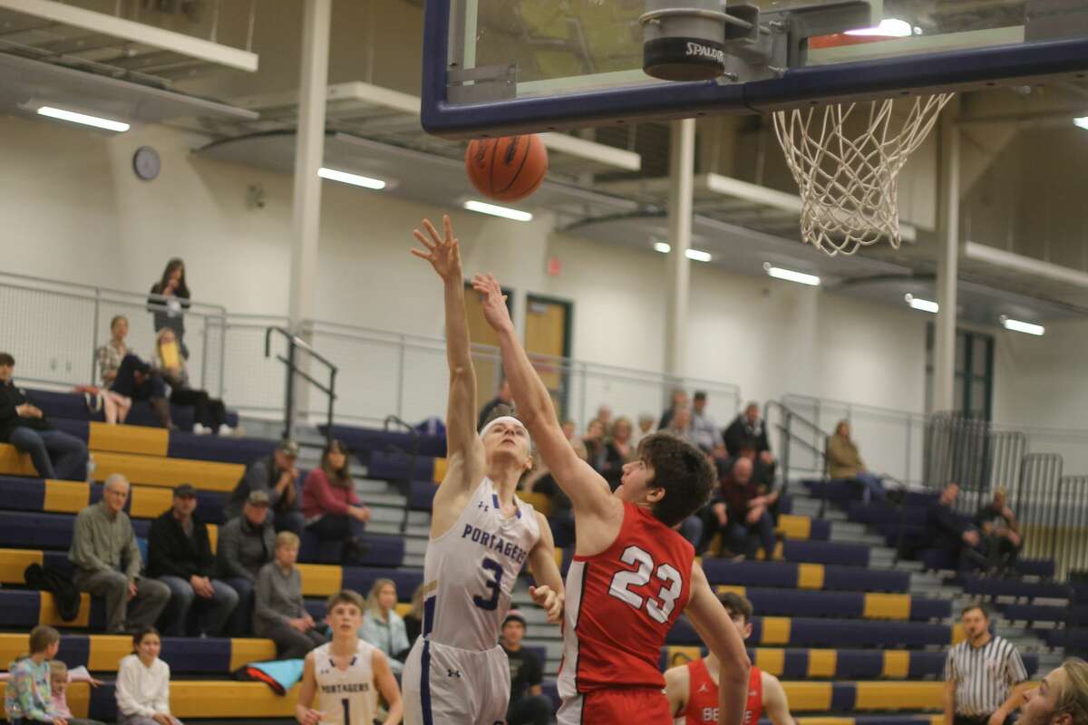 Onekama's Nate Corey puts up a shot during the Portagers' 84-31 home loss to Benzie Central on Friday night.