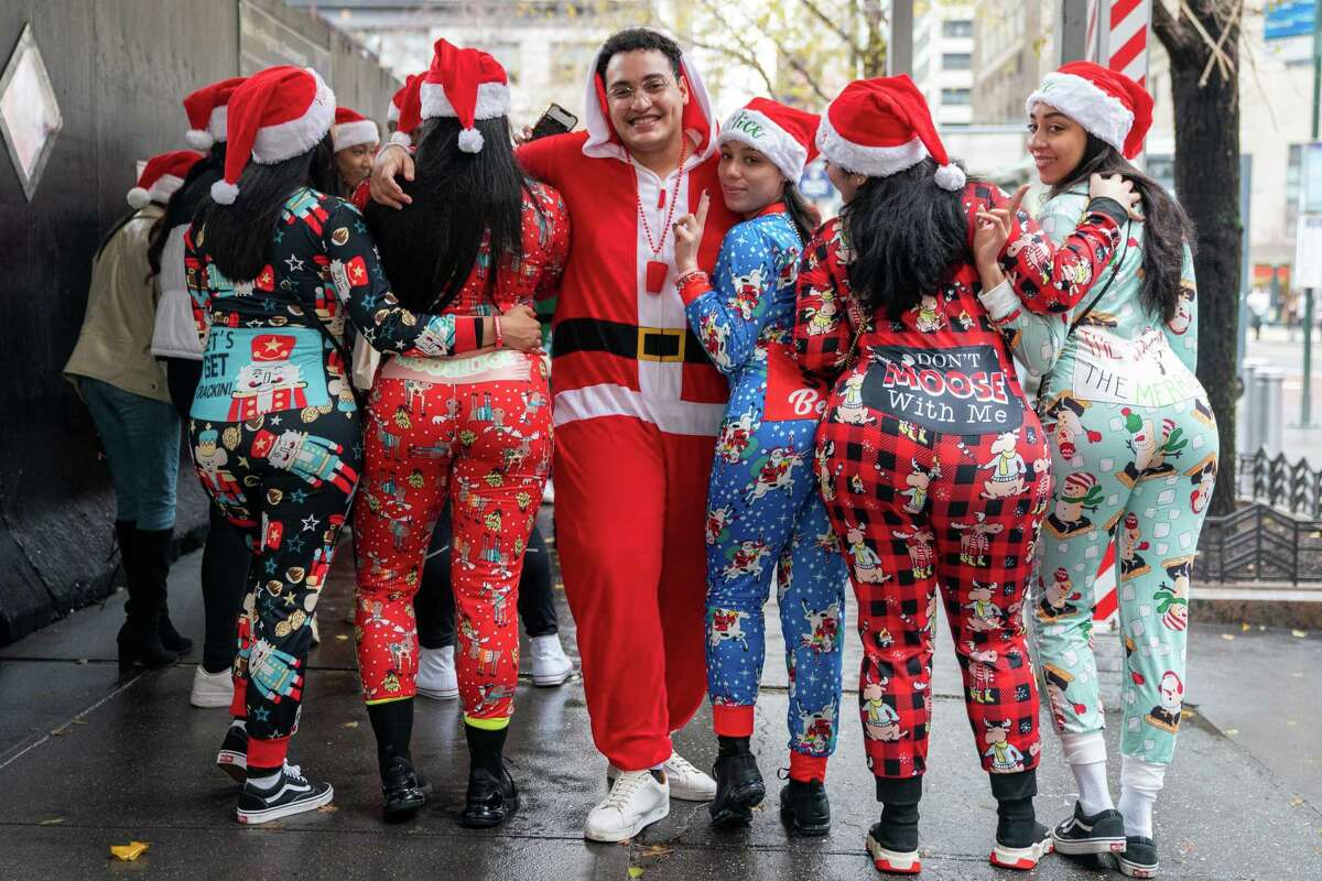 NEW YORK, NEW YORK - DECEMBER 11: People dressed in Santa Claus costumes participate in SantaCon on December 11, 2021 in New York City. SantaCon, an annual Christmas themed pub crawl raising money for charity, returned this year after it was cancelled in 2020 due to the coronavirus pandemic. People officially participating in SantaCon this year were required to be vaccinated in order to enter the bars affiliated with it. (Photo by David Dee Delgado/Getty Images)