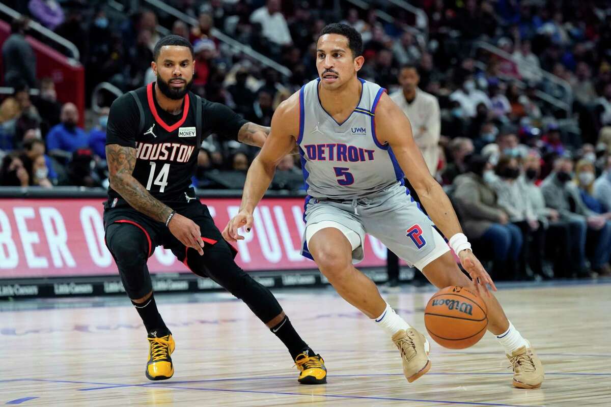 Detroit Pistons guard Frank Jackson (5) drives as Houston Rockets guard D.J. Augustin (14) defends during the first half of an NBA basketball game, Saturday, Dec. 18, 2021, in Detroit. (AP Photo/Carlos Osorio)