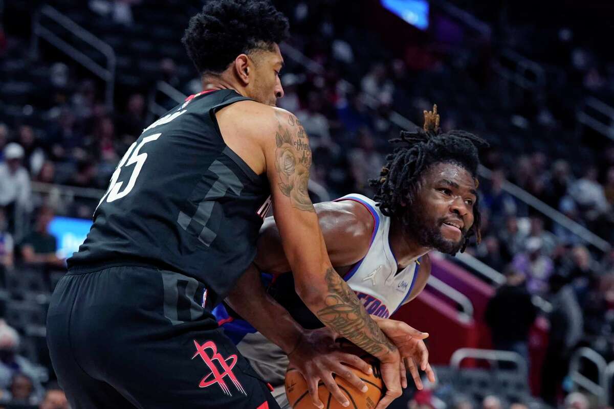Houston Rockets center Christian Wood (35) reaches in on Detroit Pistons center Isaiah Stewart during the first half of an NBA basketball game, Saturday, Dec. 18, 2021, in Detroit. (AP Photo/Carlos Osorio)
