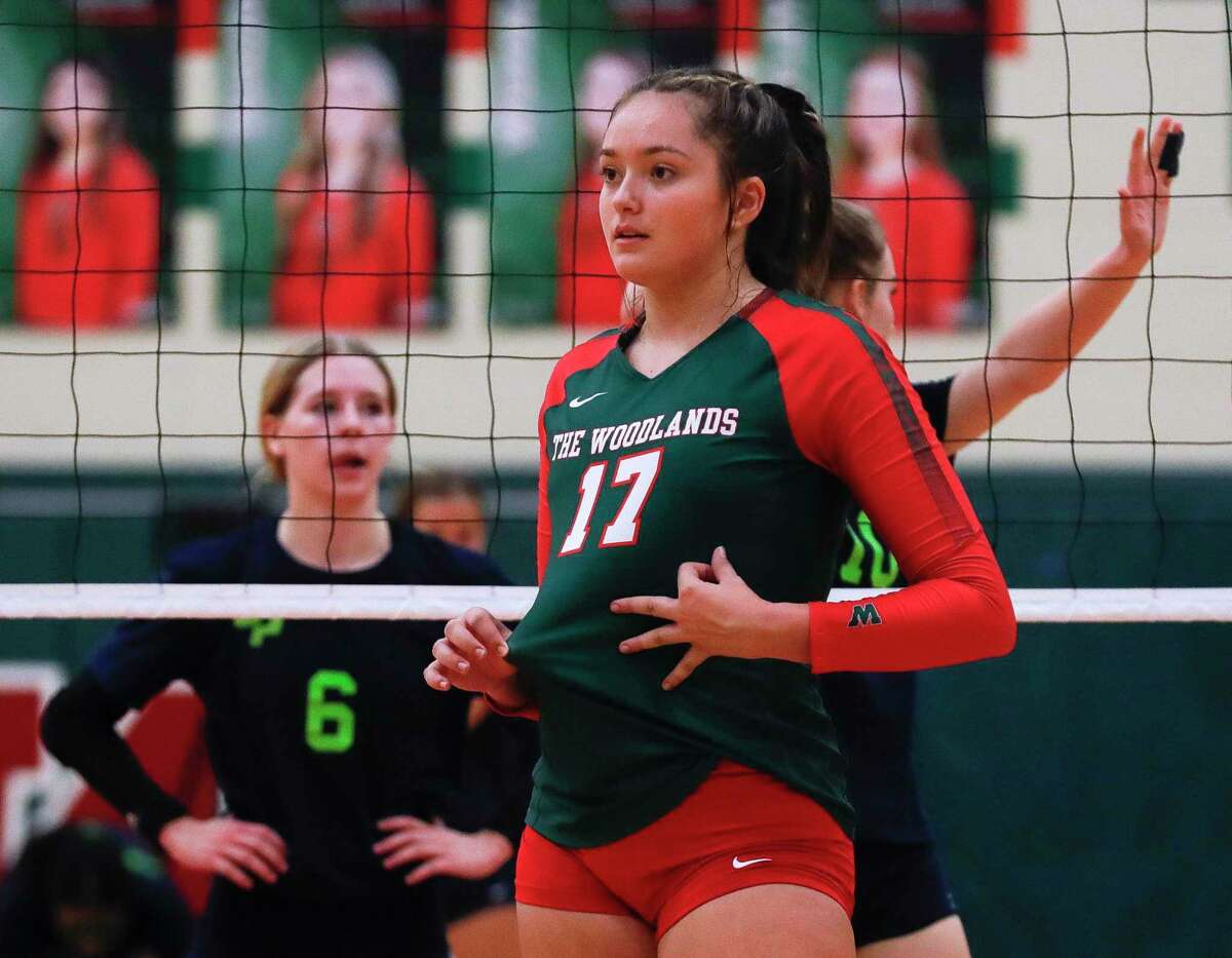 The Woodlands’ Claire Dewine (17) signals a set during the second set of a high school volleyball match at The Woodlands High School, Tuesday, Oct. 5, 2021, in The Woodlands.