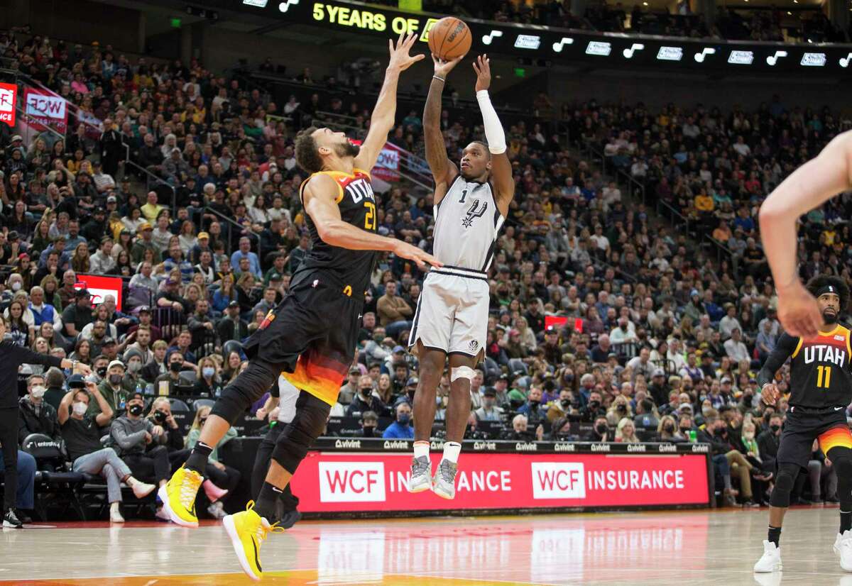 Spurs guard Lonnie Walker shoots the go-ahead basket over Jazz big man Rudy Gobert to give the Spurs a one-point lead with 14.9 seconds left Friday. The Spurs ended Utah’s eight-game winning streak.