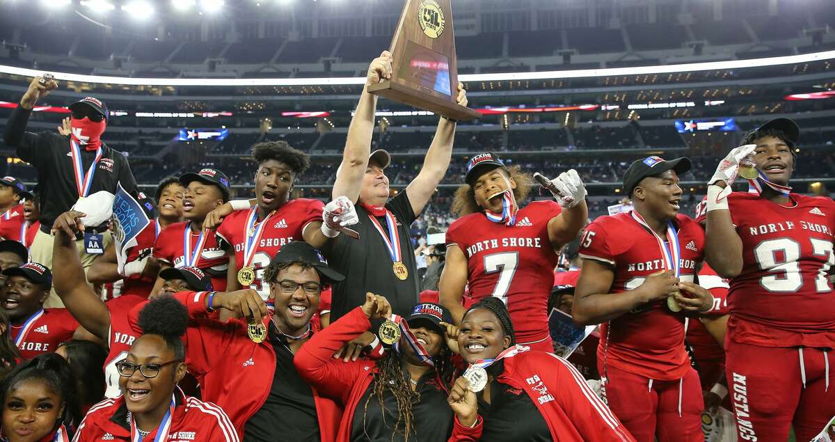 North Shore head coach Jon Kay holds up the 6A Division 1 State Championship trophy after the team defeated Duncanville for the title at At&T Stadium in Arlington on Saturday, Dec. 18, 2021. North Shore won the game 17-10.