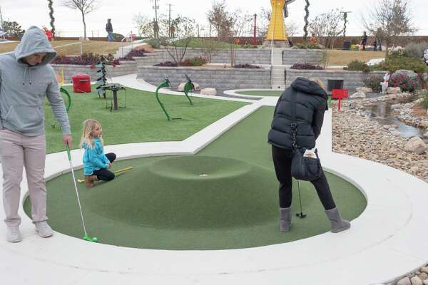 Midland families enjoy a brisk game of miniature golf 12/18/2021 during the Christmas on the Green at Green Acres Miniature Golf. Tim Fischer/Reporter-Telegram