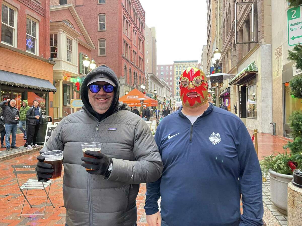 Matt Sullivan, left, known as BigLarryForearm on Twitter, and Mister Hot Balls, right, at the Pratt Street block party before UConn's game Saturday against Providence.