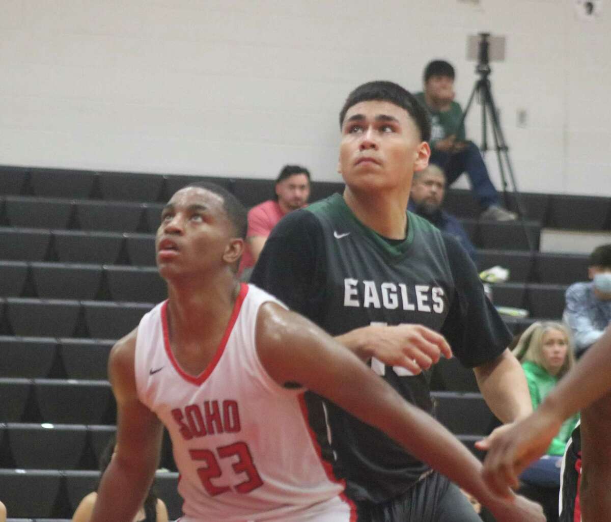 South Houston's Mijai Mickles (23) attempts to keep Pasadena's Kevin Juarez away from a possible errant foul shot attempt during Saturday's game.