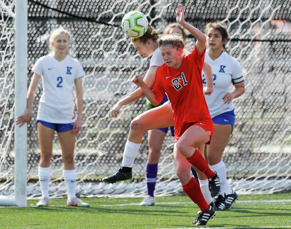 The Woodlands’ Emma Cahill (21) goes for a header against Klein’s Ella Brown (15) in the first period of a match during the Lady Highlander Invitational at Gosling Sports Field, Thursday, Jan. 7, 2021, in The Woodlands.