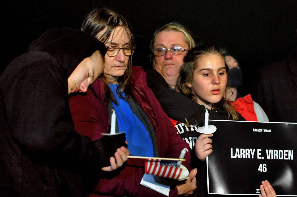 Family members of Larry Virden during a candlelight vigil on Friday for him and five other workers killed while working in an Amazon warehouse last week in Edwardsville by a tornado.