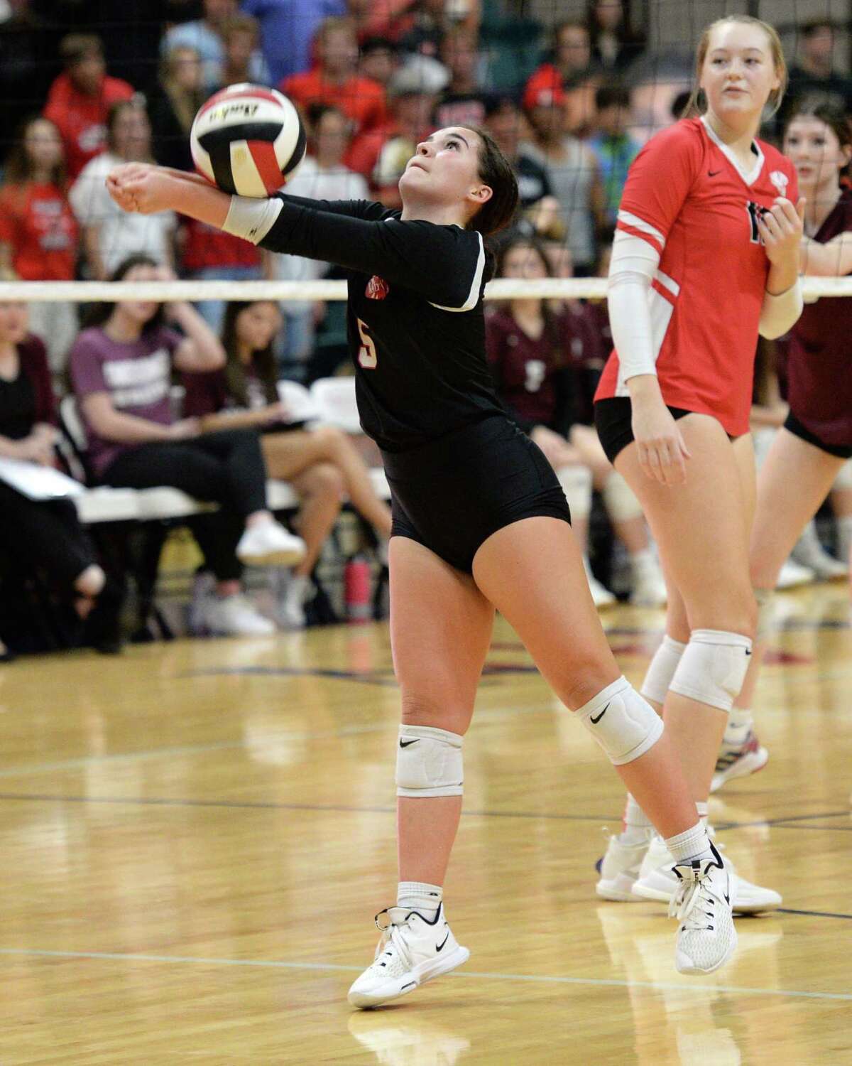 Izzy Denton (5) of Katy digs for a ball during the fourth set of a 6A-III regional quarterfinal playoff match between the Cinco Ranch Cougars and the Katy Tigers on Tuesday, November 9, 2021 at the Leonard Merrell Center, Katy, TX.