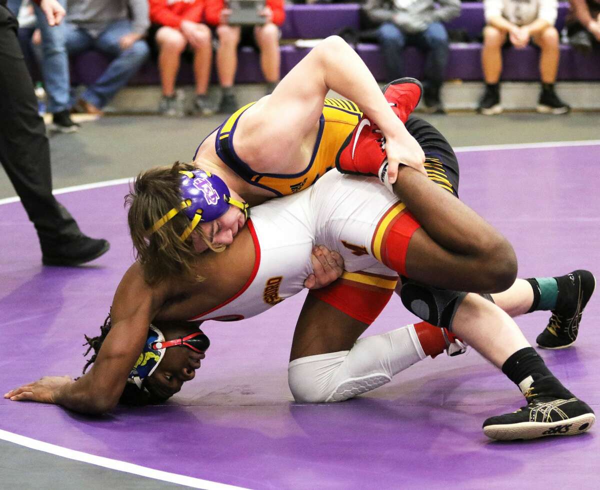 CM's Bryce Griffin (top) keeps Murphysboro's Arojae Hart from escaping during a 30-second overtime period in the 138-pound championship match Saturday at the 51st Mascoutah Invitational wrestling tournament in Mascoutah. Griffin avenged an early season defeat to Hart.