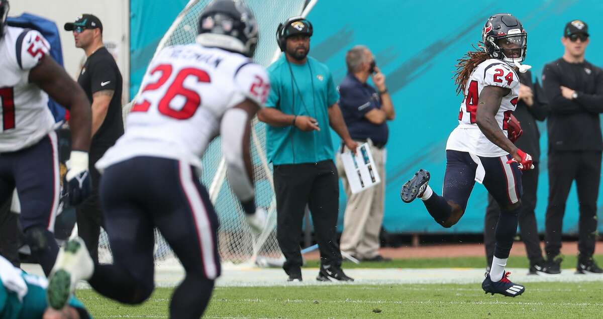 Houston Texans cornerback Tremon Smith (24) looks back over his shoulder as he runs to 98-yard kick return for a touchdown against the Jacksonville Jaguars during the first quarter of an NFL football game Sunday, Dec. 19, 2021, in Jacksonville.