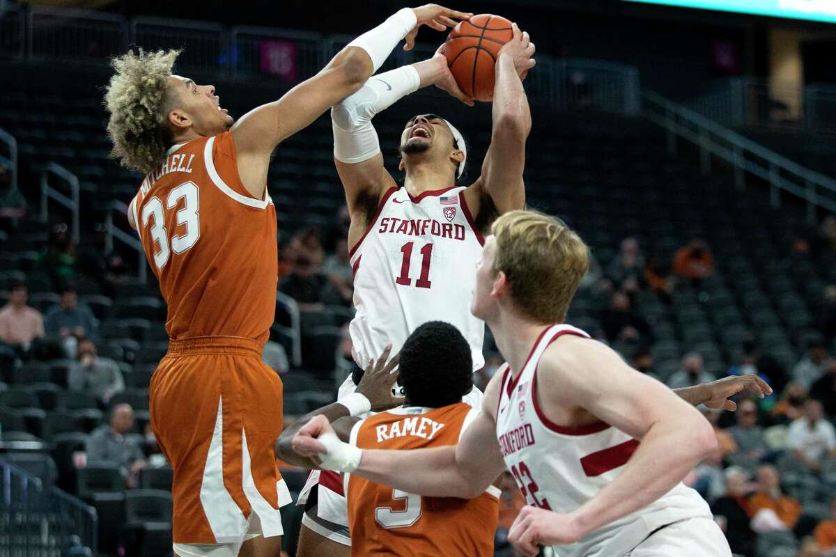 Texas forward Tre Mitchell (33) blocks a shot by Stanford forward Jaiden Delaire (11) while Texas guard Courtney Ramey, bottom center, and Stanford forward James Keefe (22) look on during the second half of a Pac-12 Coast-to-Coast Challenge NCAA college basketball game Sunday, Dec. 19, 2021, in Las Vegas. 