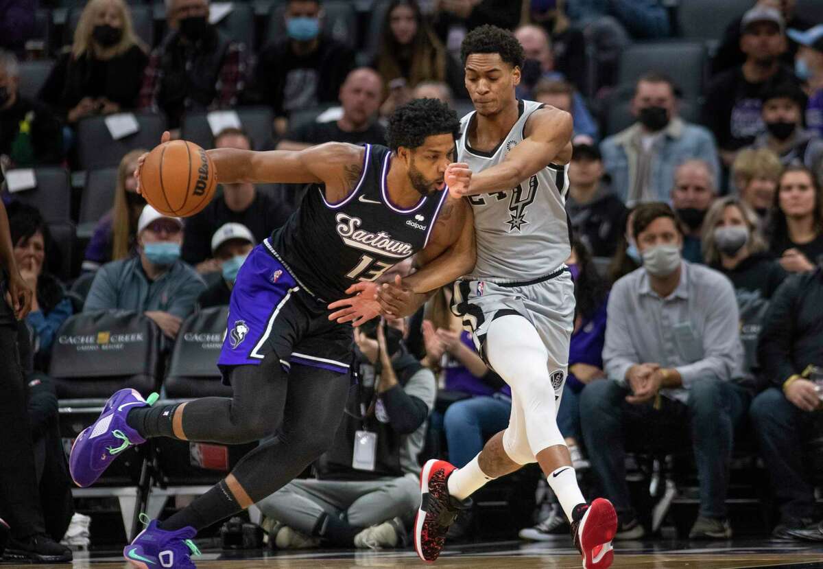 Spurs guard Devin Vassell, who started his first game of the season in place of Doug McDermott, guards Kings center and ex-UT star Tristan Thompson during the first quarter.
