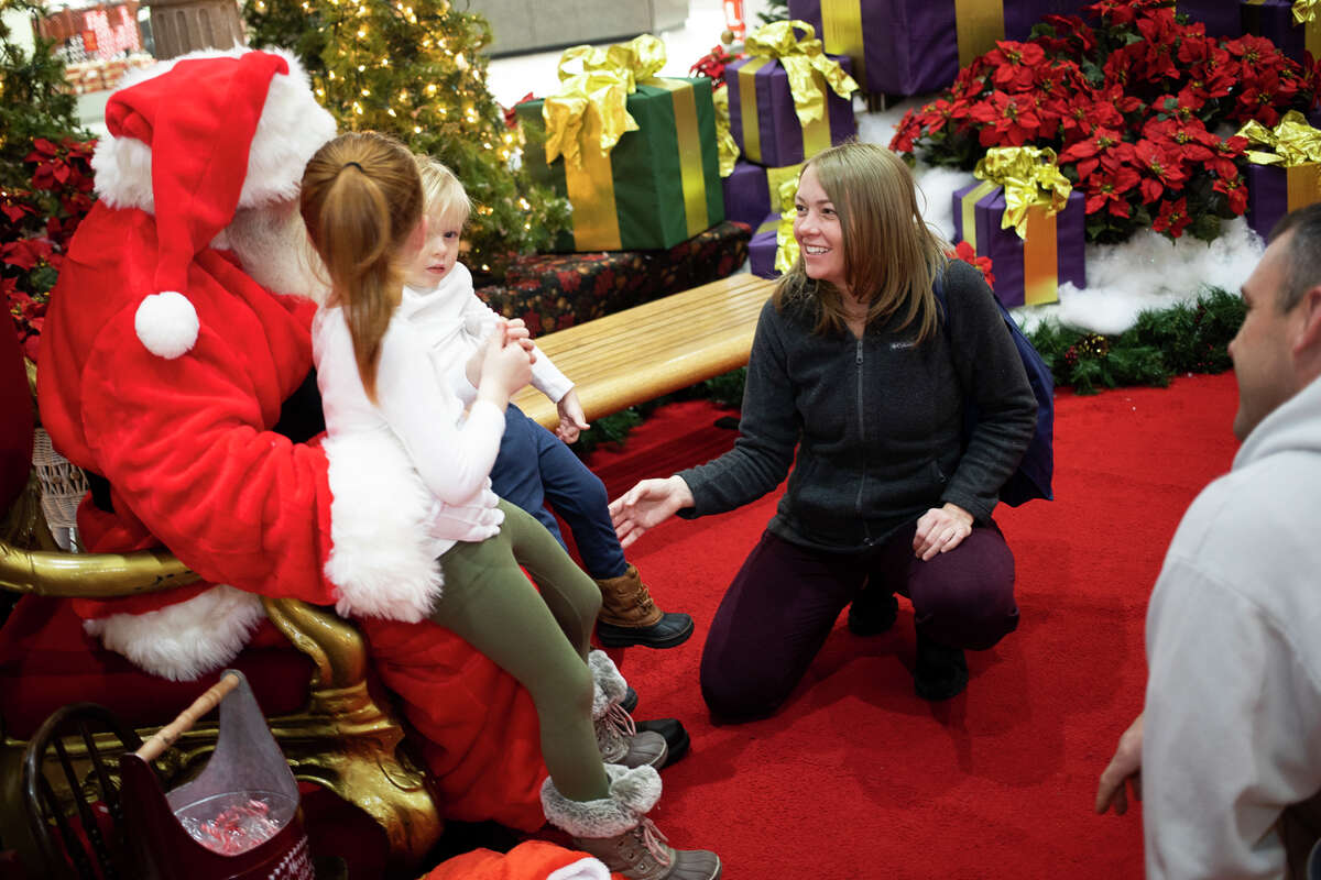Santa Claus chats with families Friday, Dec. 17, 2021 at the Midland Mall.