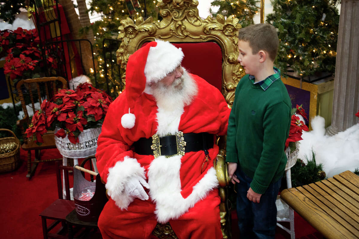 Santa Claus greets a child on Friday, Dec. 17, 2021 at the Midland Mall.