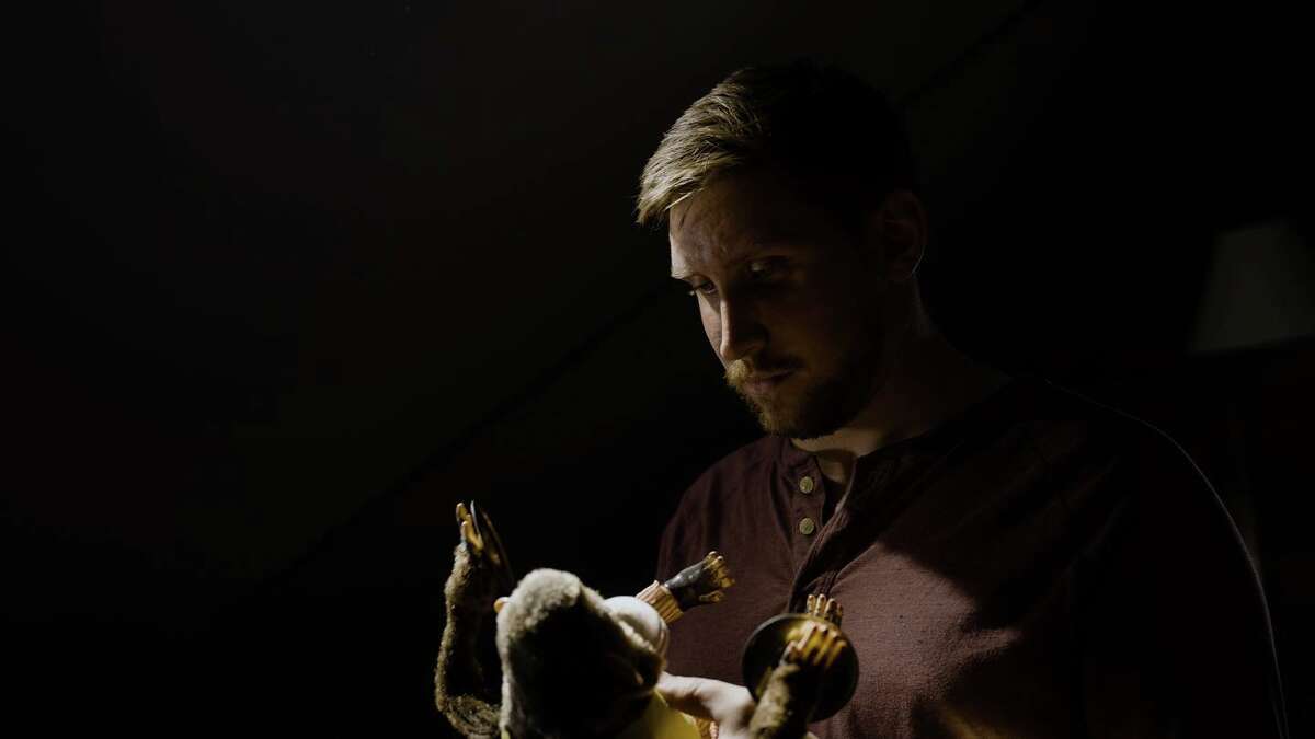 Local filmmaker Spencer Sherry stares thoughtfully at a toy monkey, the subject of his proposed short film, "The Monkey," as well as the Stephen King short story that inspired it. 