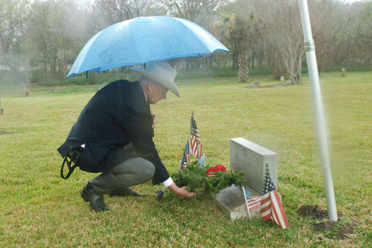 Sons of the Republic of Texas representative Steve Dunbar places a wreath near the marker of World War II veteran and Pasadena resident Ben Gutierrez as part of the National Wreaths Across America event Saturday at historic Crown Hill Cemetery in Pasadena. Guttierez, a member of the Army’s 160th Infantry Division, was killed at age 23 in 1944 as American troops fought to recapture the island of Guam from Japanese forces.
