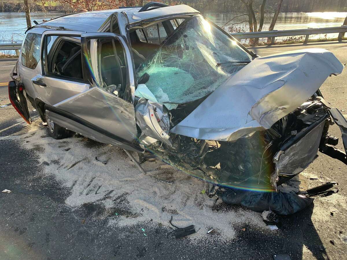 A sport utility vehicle rolled over on Friday, Dec. 17, 2021, after crashing into a utility pole on River Road in Shelton, Conn.