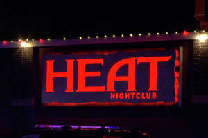 An employee at The Heat nightclub was caught in a crossfire and struck by a bullet after a fight broke out between patrons on Sunday, according to authorities. 