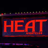An employee at The Heat nightclub was caught in a crossfire and struck by a bullet after a fight broke out between patrons on Sunday, according to authorities. 